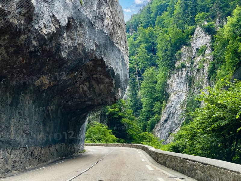 Mountain road in the Western Alps in the style of a balcony road with rock overhang above the carriageway, departmental road D512 Route du Col de Porte north of Grenoble, Sarcenas, Arrondissement Grenoble, Département Isère, Region Auvergne-Rhône-Alpes, France