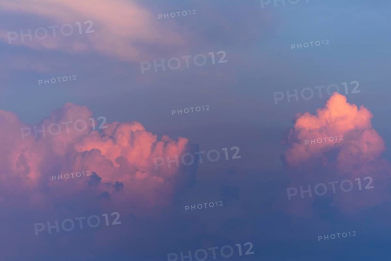 Soft pink and purple clouds float against a blue sky, capturing the calming beauty of twilight. This enchanting scene evokes tranquillity and wonder as day fades into night. Bas rhin, Alsace, grand est, France