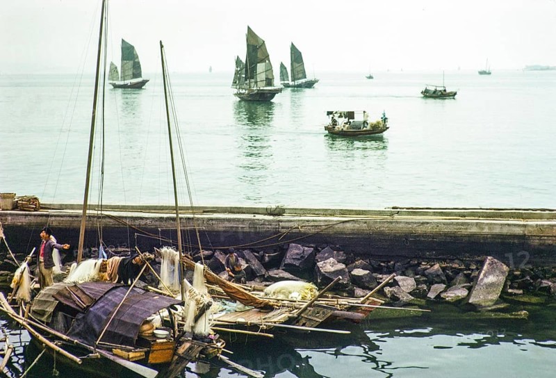 Junk ships at sea people living on sampan boats in the harbour thought to be at Causeway Bay, Hong Kong, Asia 1964