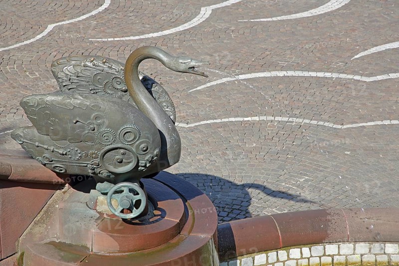 Castle fountain with swan figure by Gernot Rumpf 1984, water jet, bronze sculpture, modern art, detail, reliefs, hand wheel, swan neck, fountain, Schlossplatz, Pirmasens, Rhineland-Palatinate, Germany