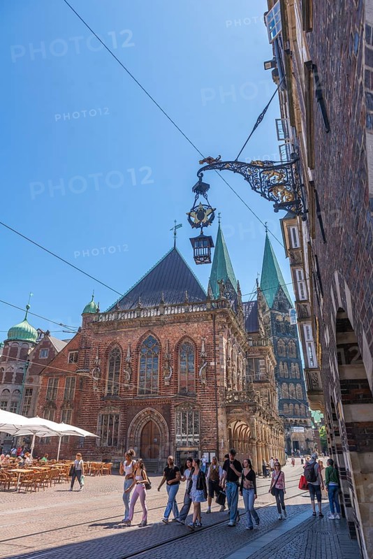 View of the old town hall, UNESCO World Heritage Site, and St Peter's Cathedral with double tower, arcade, sign, hanging lantern, blue sky, Old Town, Bremen, Germany