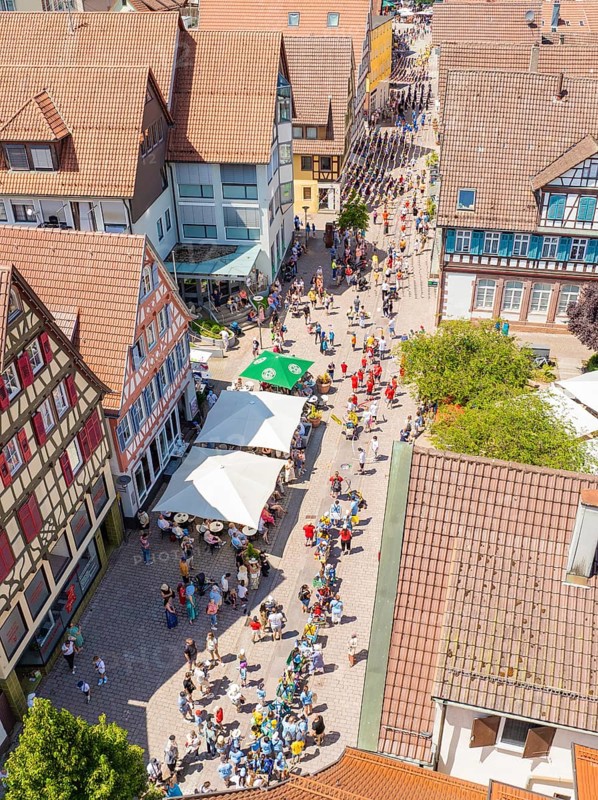 Aerial view of a busy street with half-timbered houses and cafés with parasols, many passers-by, 950 years of Calw, Calw parade, Black Forest, Germany