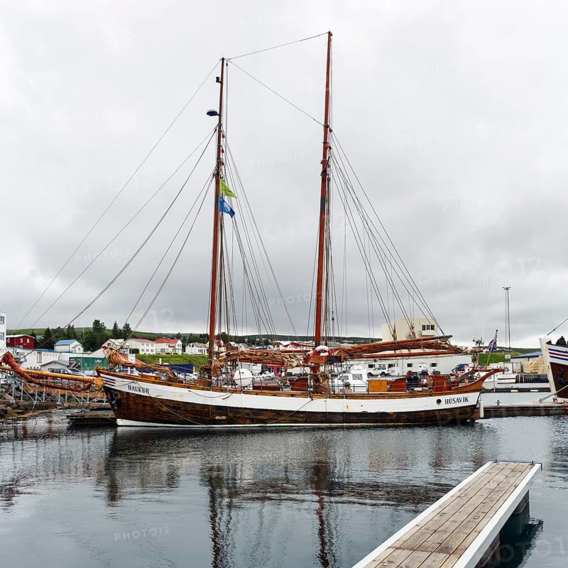 Sailing boat in the harbour, fishing village at Skjalfandi Bay, rain clouds, Husavik, Húsavík, North Iceland, Iceland