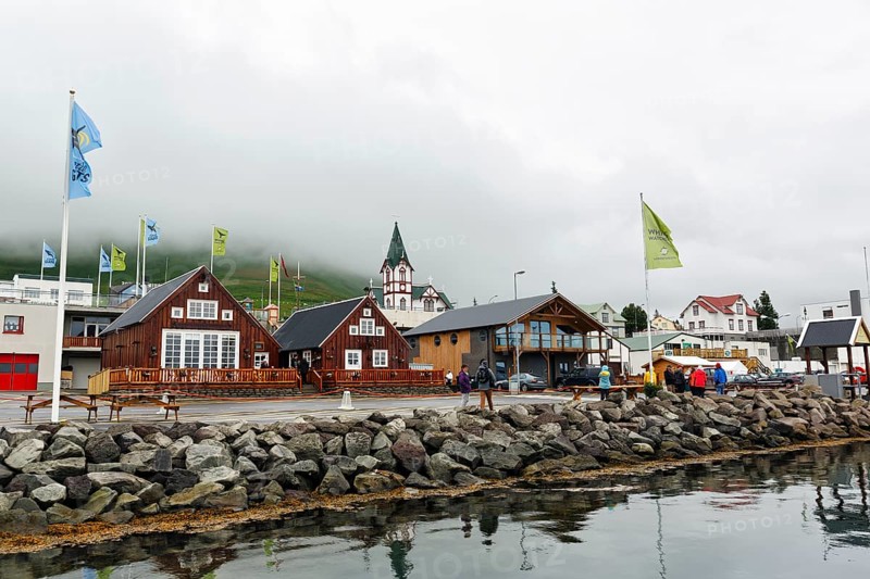 Old wooden houses with church, fishing village at Skjalfandi Bay, rain clouds, Husavik, Húsavík, North Iceland, Iceland