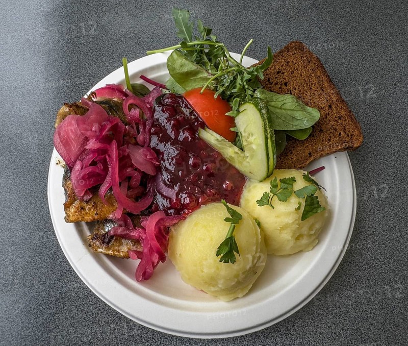 Typical Swedish meal: Fried herring with mashed potatoes, lingonberry jam, bread and vegetables