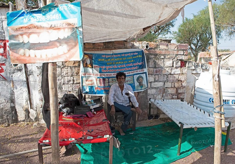 Indian man at a dentist stand in the Thar Desert or Great Indian Desert, near Jaisalmer, Rajasthan, India