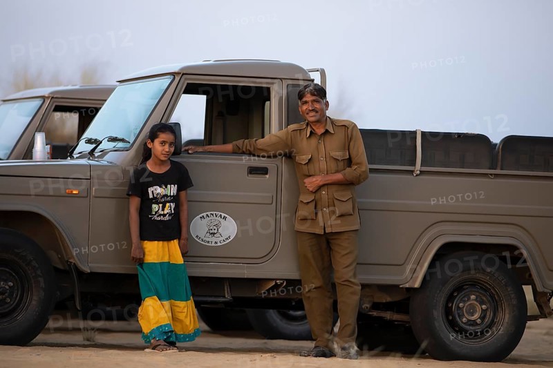 Indian man and Indian girl on a desert jeep, desert dwellers in the Thar Desert or Great Indian Desert, near Jaisalmer, Rajasthan, India