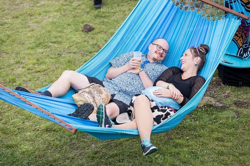 Two festival visitors lying in a hammock in the Fashion Palooza at the Lollapalooza Festival in the Olympiastadion and on the Maifeld, Berlin, 13 July 2025