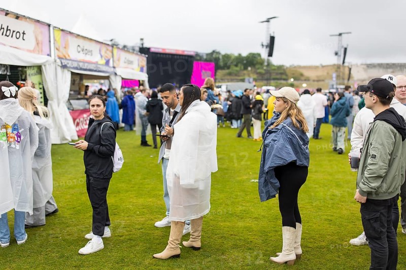 Festival visitors in front of a food stand at the Lollapalooza Festival in the Olympic Stadium and on the Maifeld, Berlin, 12 July 2025