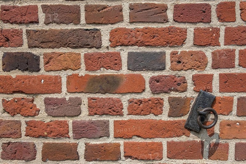 Detail of a brick wall, brick wall with a rusty metal ring, Münsterland, North Rhine-Westphalia, Germany