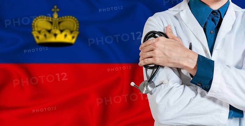 Doctor with stethoscope on Liechtenstein flag. Doctor holding stethoscope on Liechtenstein flag