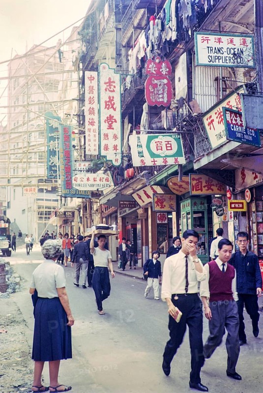 Captioned as 'Chinese flower stalls', Victoria, Hong Kong, Asia 1964 - note bamboo scaffolding