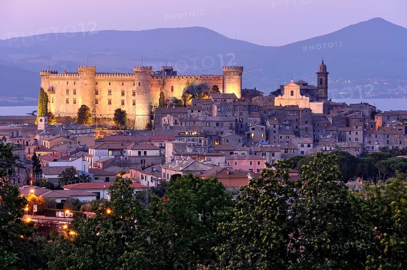 Fortress Castello Odescalchi, Duomo Santo Stefano, illuminated, blue hour, behind Bracciano Lake, Lago di Bracciano, historic centre, Bracciano, metropolitan city of Rome, Lazio, Italy