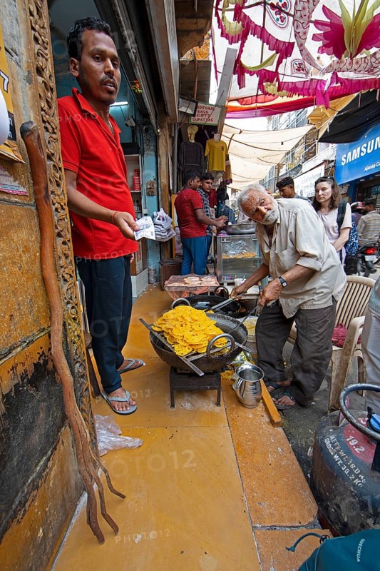Indian man frying local sweet in the old town of Jaisalmer, Rajasthan, India