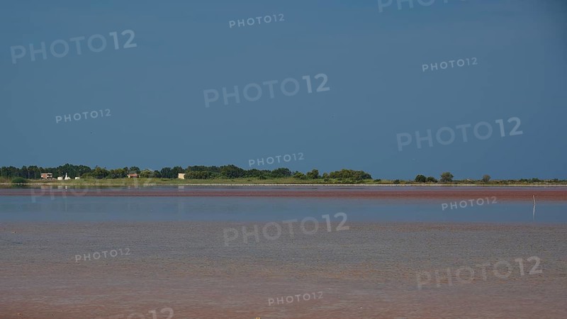 Tranquil coastal scene with blue sky and reflecting water, salt lake, Tigaki, nature reserve, hydro biotope, Kos, Dodecanese, Greek Islands, Greece