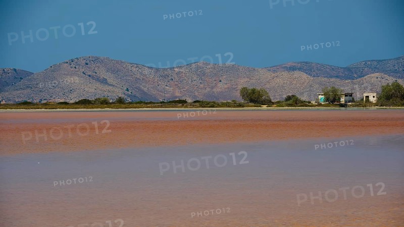 Mountainous landscape with calm lake and small huts under a bright blue sky, salt lake, Tigaki, nature reserve, hydro biotope, Kos, Dodecanese, Greek Islands, Greece