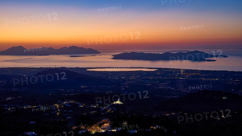 Sweeping panoramic view of coastal landscape at sunset, shadows and city lights visible, salt lake, Tigaki, nature reserve, hydro biotope, Kos, Dodecanese, Greek Islands, Greece