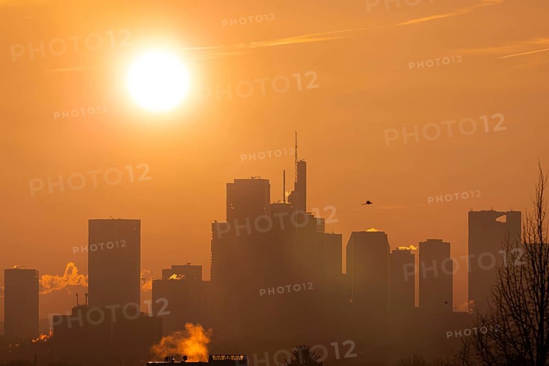 The sun rises behind Frankfurt's banking skyline, Frankfurt am Main, Hesse, Germany