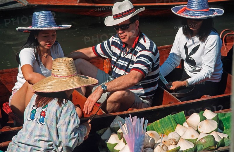 Dealer and customer in their boats at the Damnoen Saduak floating market, Thailand, December 2002, vintage, retro, old, historic