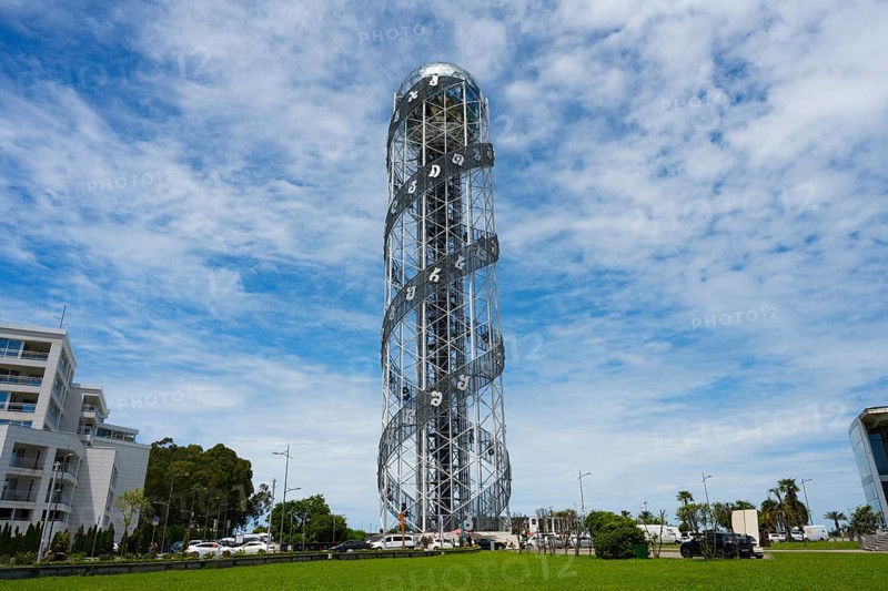 Large steel tower with spiral architecture against a slightly cloudy sky, Alphabetic Tower, Georgian Alphabet Tower, Miracle Park, Batumi, Black Sea, Ajara region, Adjara, Autonomous Republic, Georgia