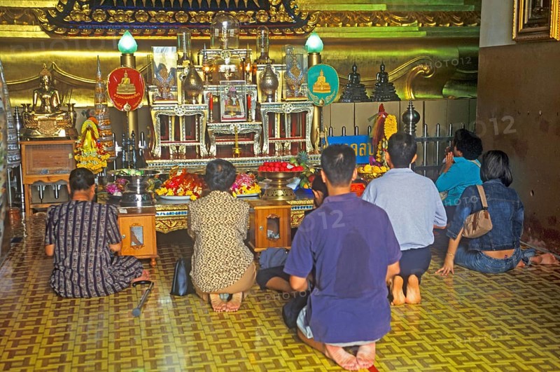 People praying in the temple with the Buddha statue Phra Mongkhonbophit, Ayutthaya, Thailand, December 2002, vintage, retro, old, historic