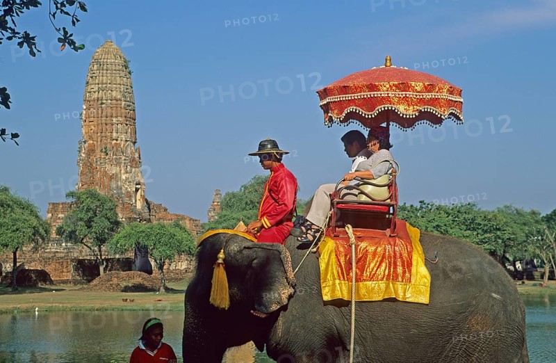 People, tourists, temple ruins, riding on an elephant through ancient sights, Ayutthaya, Thailand, December 2002, vintage, retro, old, historical