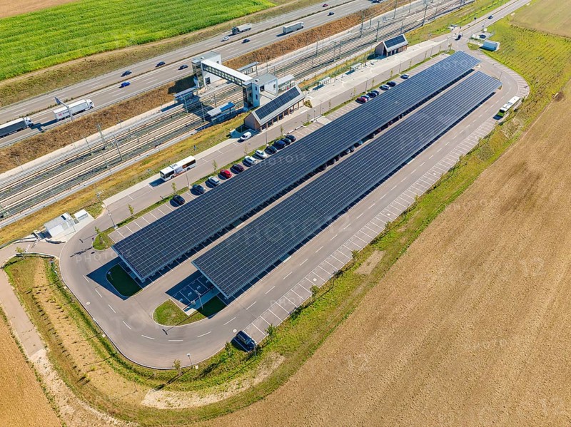 Solar system with parking spaces next to a well-traveled motorway and fields, e-charging park, Merklingen, Germany