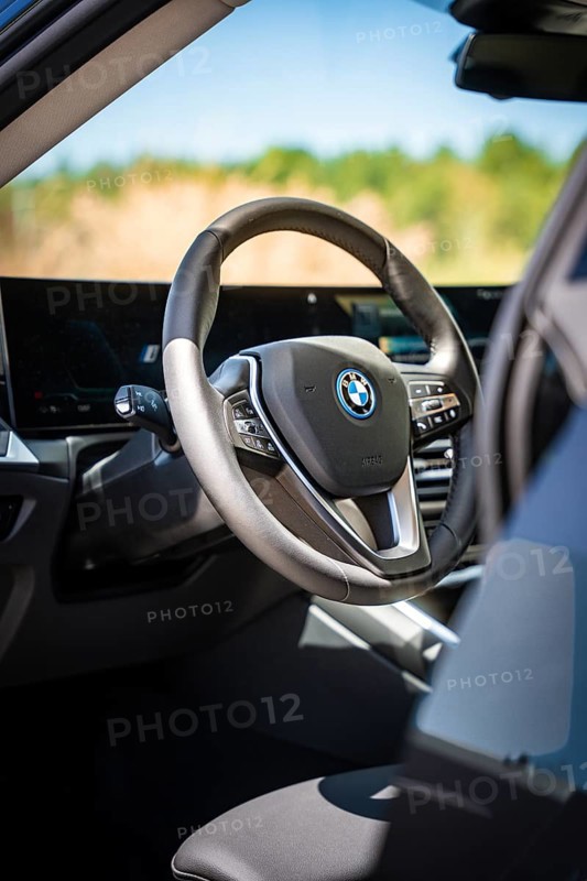 View of the modern steering wheel and display in the interior of a car, BMW i7 electric car, Deer e-Carsharing, Calw, Germany