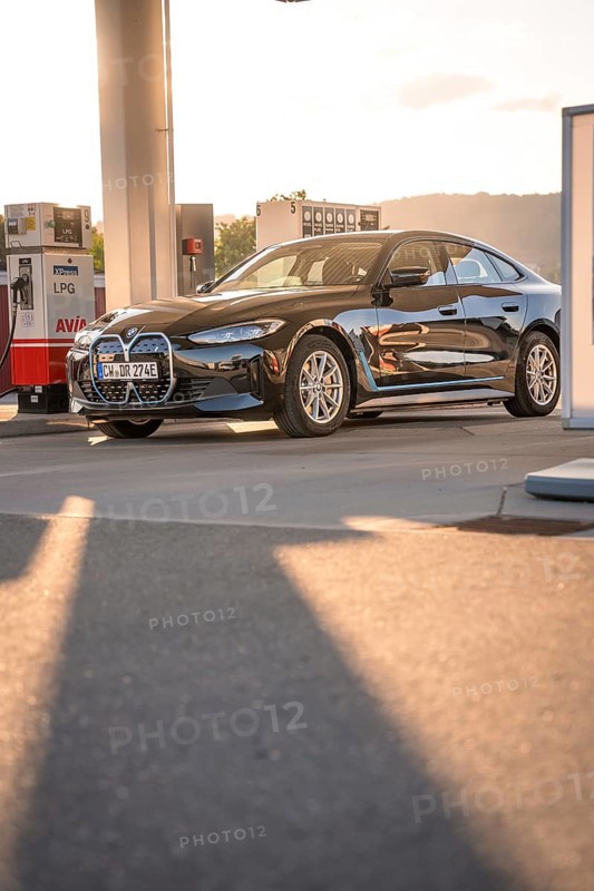 BMW at a gas station with incoming sunlight, BMW i7 electric car, Deer e-Carsharing, Calw, Germany