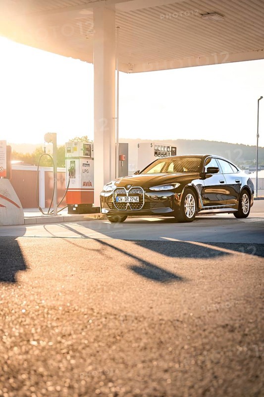 BMW at a gas station during sunset, BMW i7 electric car, Deer e-Carsharing, Calw, Germany