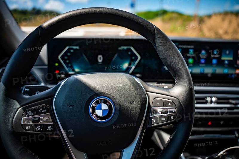 The modern steering wheel of a car with tech-heavy dashboard and display, BMW i7 electric car, Deer e-Carsharing, Calw, Germany