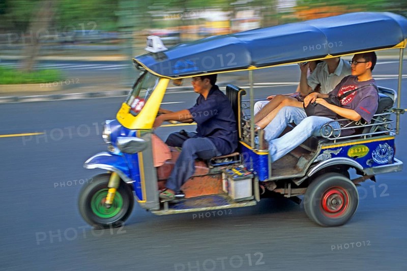 Tourists in a three-wheeled tuk tuk taxi, blurred, Bangkok, Thailand, December 2002, vintage, retro, old, historic