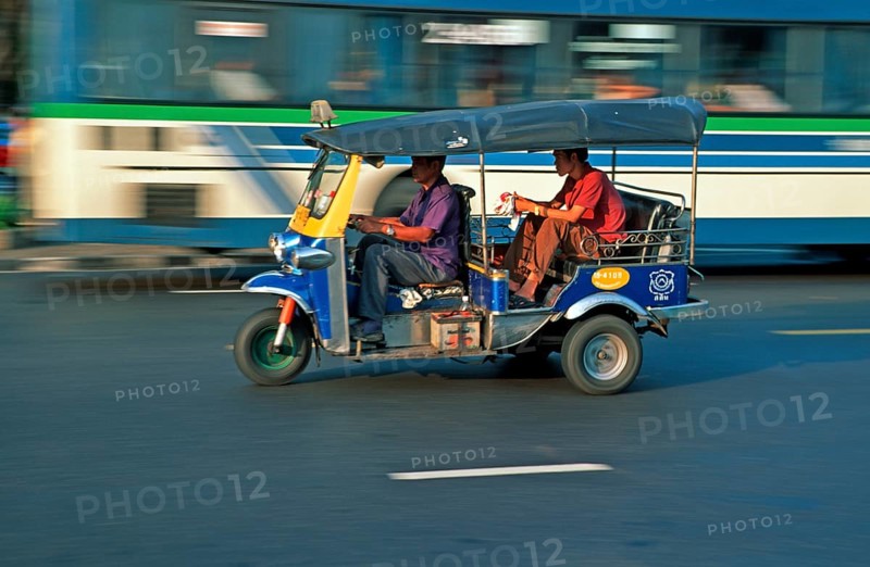 Passenger in a three-wheeled tuk tuk taxi, blurred, Bangkok, Thailand, December 2002, vintage, retro, old, historic