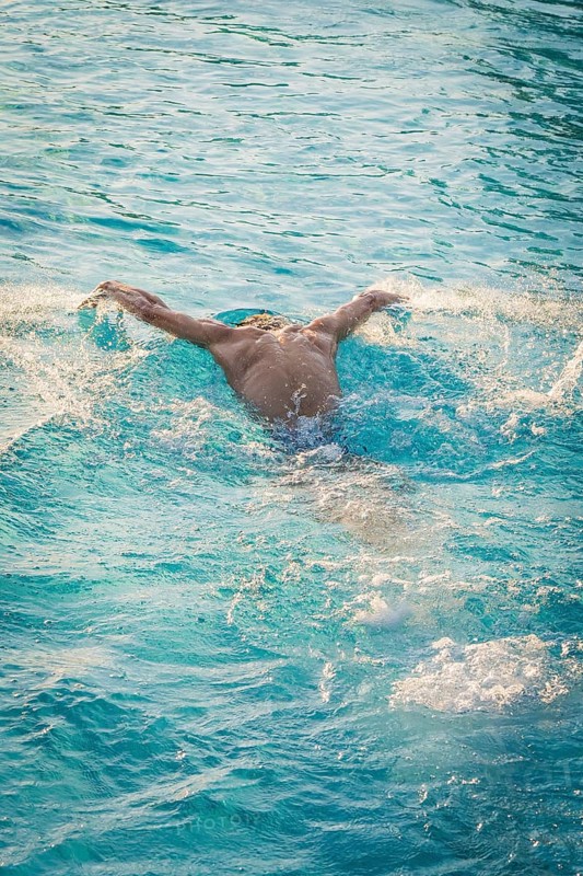 A swimmer in a blue pool moves powerfully through the water, Triathlon, Calw, Germany