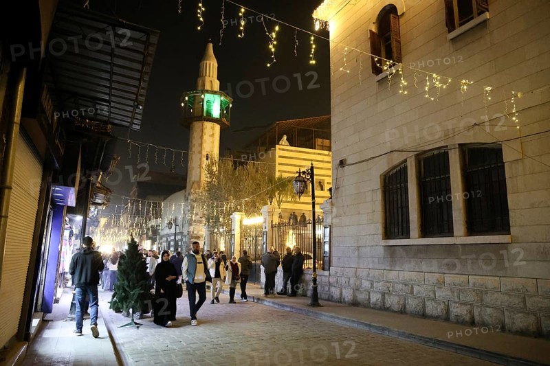 In Damascus, Syria, on December 25, 2025, festive scenes filled the streets and churches of the Bab Touma district, where thousands of people gathered to celebrate Christmas Eve amid holiday decorations and lights, Damascus, Damascus, Syria