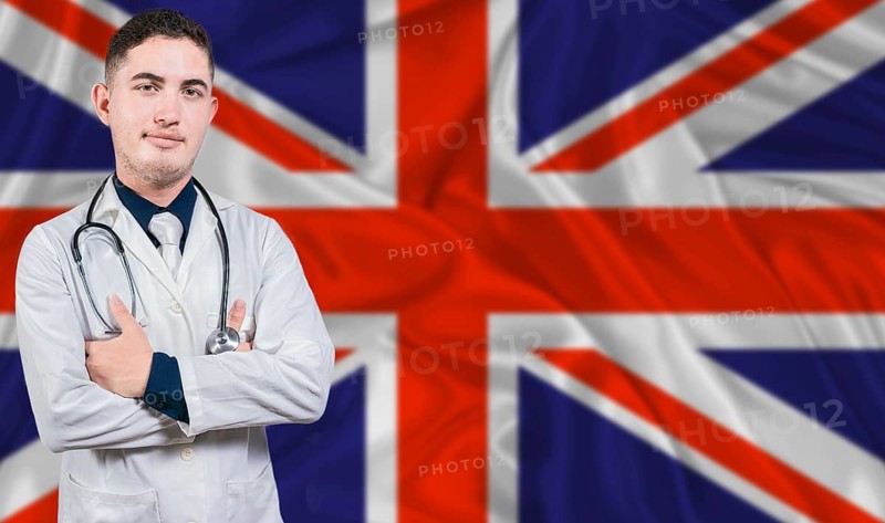 Portrait of medical professional on United Kingdom flag background. British national health system