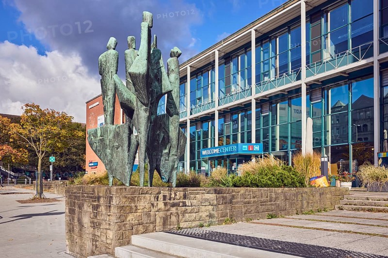 Bronze sculpture The Five Continents, sculptor Bernhard Heiliger, sandstone pedestal, welcome center, town hall, modern architecture, building, glass façade, staircase, city trees, flower bed, blue sky, cumulus clouds, Stresemannplatz, Kiel, state capital, district-free city, Schleswig-Holstein, Germany