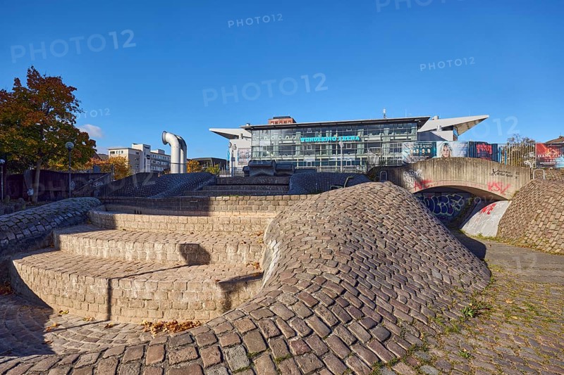 Wunderino Arena multi-purpose hall or former Baltic Sea Hall, well complex, building material brick, cobblestones and paving stones, sidewalk made of paving stones and cobblestones, barrier bollard, lantern, pedestrian zone, blue sky, cloudless, splash, Europaplatz, Kiel, state capital, district-free city, Schleswig-Holstein, Germany