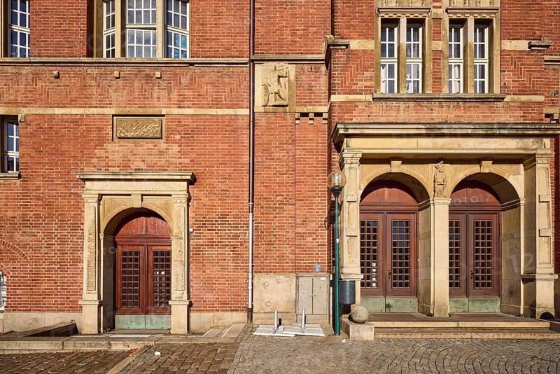 Opera house, architect Christian Heinrich Seeling, art nouveau style, brick architecture, historic brick buildings, entrance, façade with windows and doors, composite wall, sandstone and brick building material, paving stone walkway, sunny, town hall square, Kiel, state capital, district-free city, Schleswig-Holstein, Germany