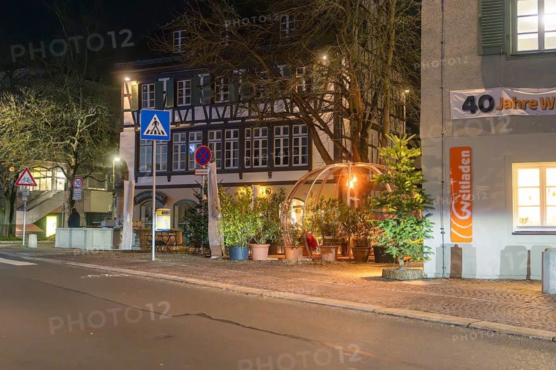 A nocturnal street scene with half-timbered house and decorative dome, surrounded by plants in lantern light, Gastro Bubbles, Sindelfingen, Germany