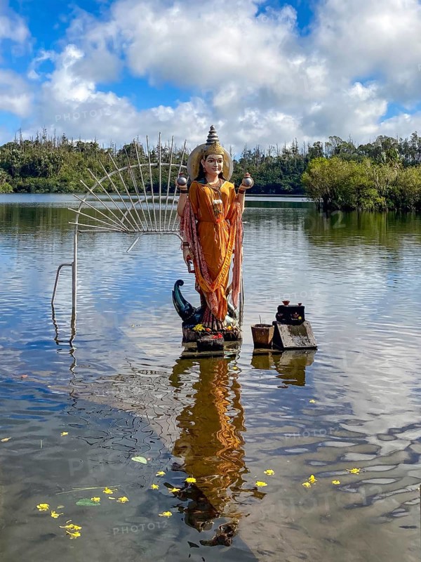 Hindu god figure figure sculpture of goddess deity Parvati woman woman woman woman Shakti of Lord Shiva Hindu mother goddess mother of Ganesha standing in sacred Hindu lake Ganga Talao at religious site largest Hindu shrine for religion Hinduism outside India for believers Hindu Hindus, in the background Sacred Lake Ganga Talao crater lake in crater of extinct volcano, Grand Basin, Le Petrin, Mauritius