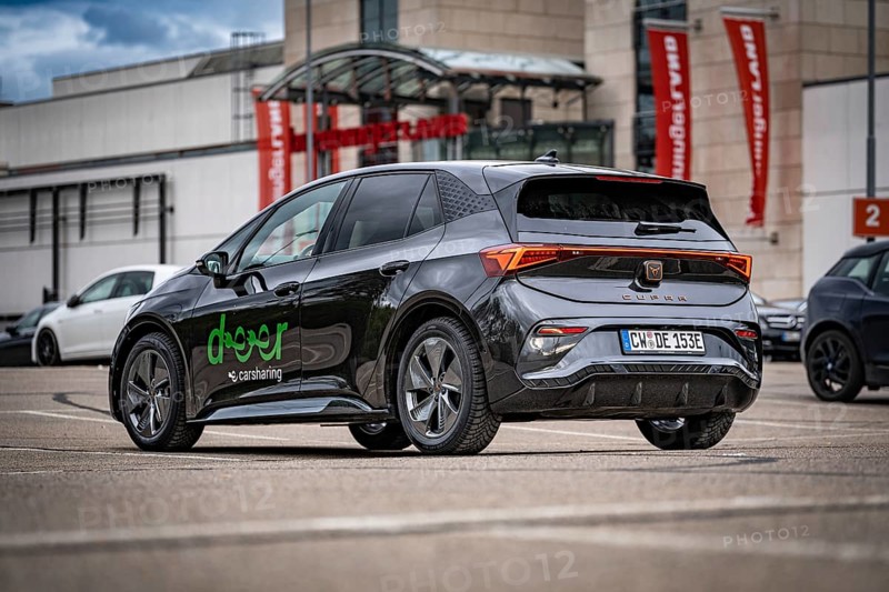 A Cupra car in a municipal parking lot with modern architecture in the background, seen from the rear view, Cupra electric car, e-car sharing, Calw, Germany