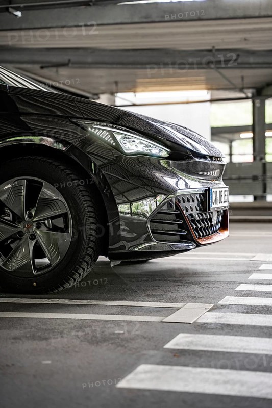 Close up of a black car in an urban parking lot from the front, electric car Cupra, e-car sharing, Calw, Germany