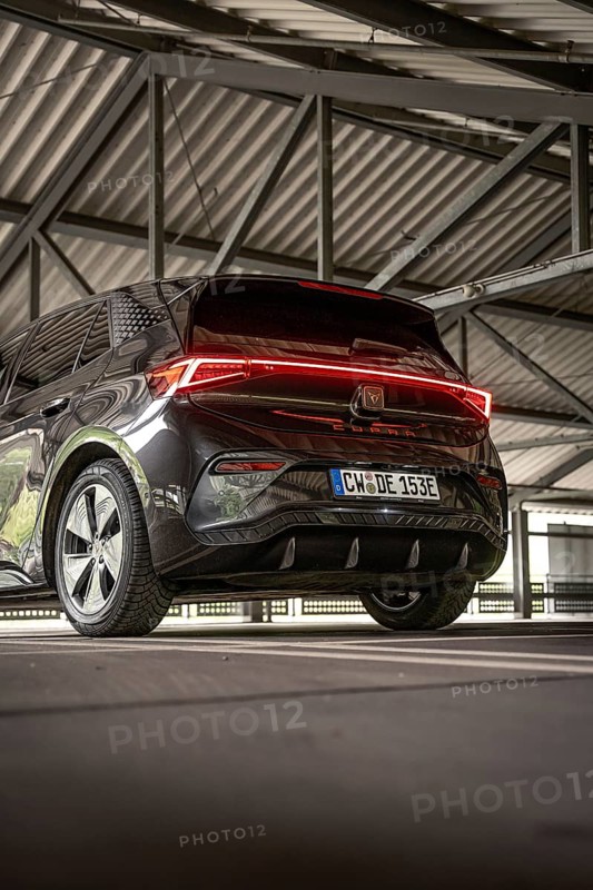 Back view of a black car under a covered parking lot, electric car Cupra, e-car sharing, Calw, Germany