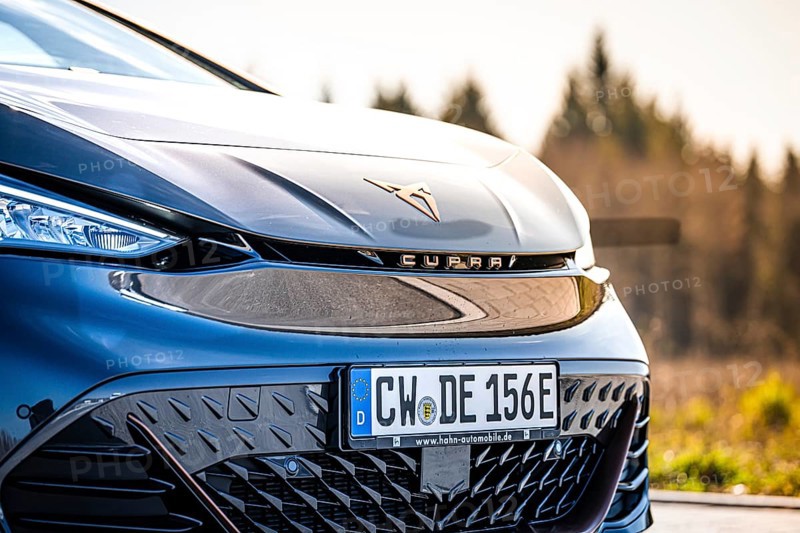 Detailed view of the front end of a stylish black car in front of a forest, electric car Cupra, e-car sharing, Calw, Germany