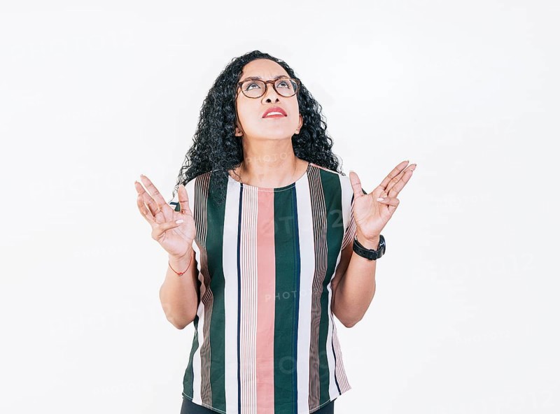 Young woman screaming with her hands in the air. Frustrated girl screaming with hands in the air isolated