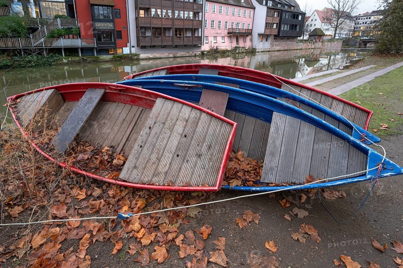 Assembled rowing boats on the banks of Pegnitz, river in Nuremberg, Middle Franconia, Bavaria, Germany
