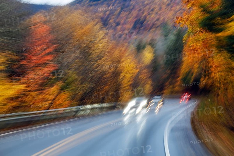 Car, light trails, rain-wet road, curvy country road, autumn leaves, Indian summer, smudge effect, blur, Kancamagus Highway, White Mountain, New Hampshire, New England, USA