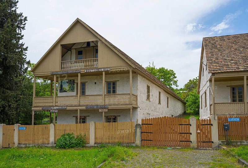 Traditional house with wooden balcony and fence in a rural setting with cloudy skies, village founded by Caucasian Germans, Asureti, Asureti, Elizabeth Valley, Lower Kartli region, Georgia
