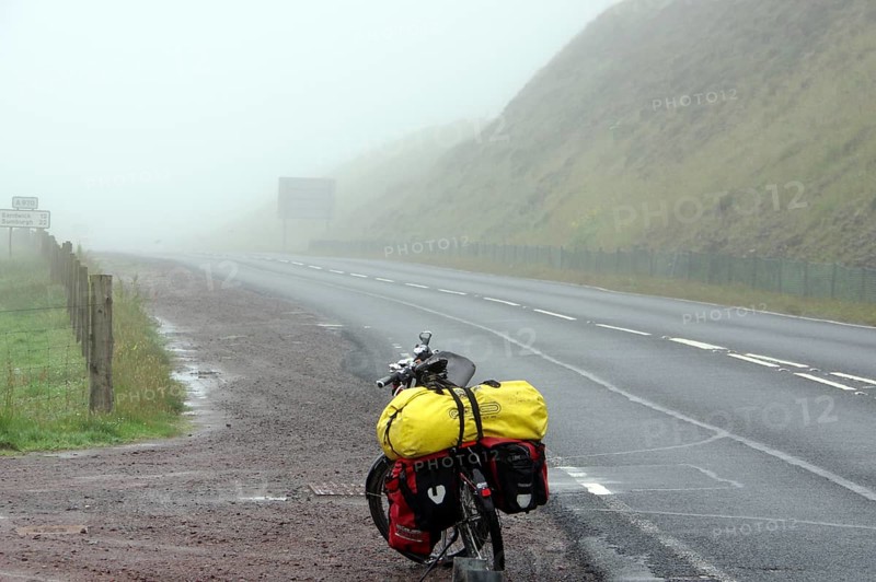 Bicycle with luggage on a foggy and deserted country road, cycle tourism, adventure, Shetlands, Shetland Islands, Scotland, Great Britain